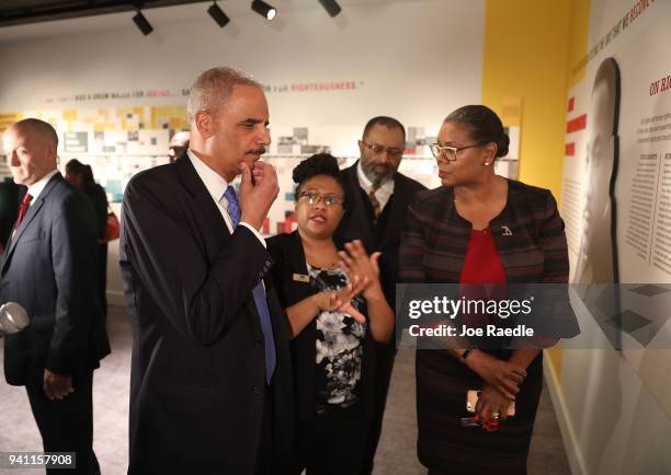 Dr. Noelle Trent gives Eric Holder, Jr., the 82nd Attorney General of the United States, a tour of the MLK50: A legacy Rembered exhibit at the...