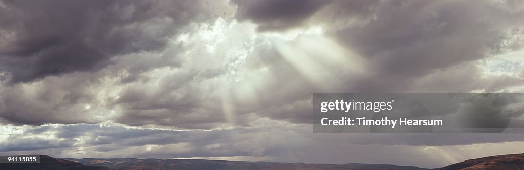 Rays of light filter through storm clouds 