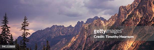 jagged mountain peaks with storm clouds - timothy hearsum fotografías e imágenes de stock
