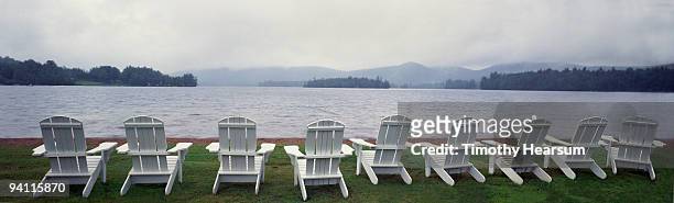 adirondack chairs overlooking lake, mountains  - timothy hearsum stockfoto's en -beelden