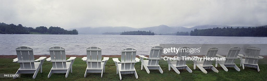 Adirondack chairs overlooking lake, mountains 