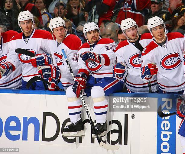 Tomas Plekanec of the Montreal Canadiens sits on the boards to join teammates celebrating a goal against the Buffalo Sabres on December 3, 2009 at...