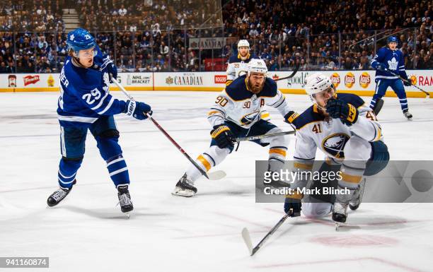 William Nylander of the Toronto Maple Leafs skates against Ryan O'Reilly and Justin Falk of the Buffalo Sabres during the first period at the Air...