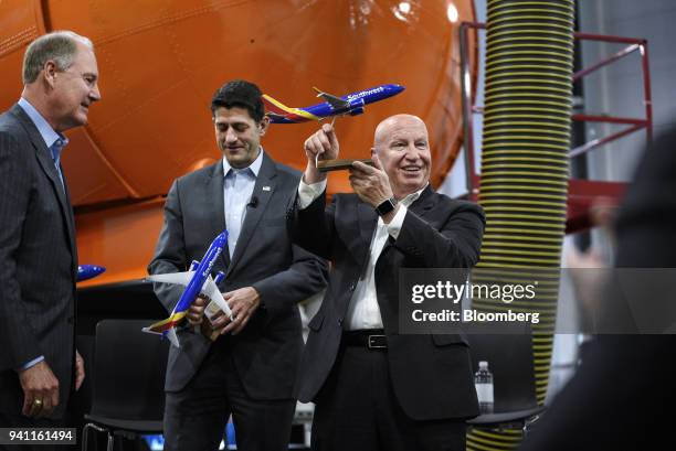 Gary Kelly, chief executive officer of Southwest Airlines Co., left, presents model planes to U.S. House Speaker Paul Ryan, a Republican from...