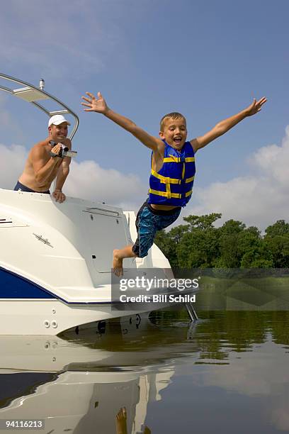 boy jumping into lake - human body part videos stock pictures, royalty-free photos & images