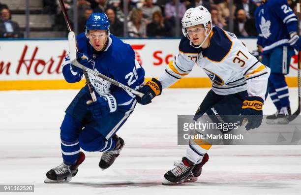 Casey Mittelstadt of the Buffalo Sabres skates against Connor Brown of the Toronto Maple Leafs during the first period at the Air Canada Centre on...