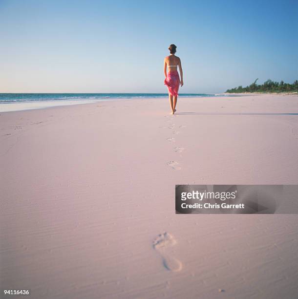 woman walking on beach at harbour island , bahamas - isla harbor fotografías e imágenes de stock
