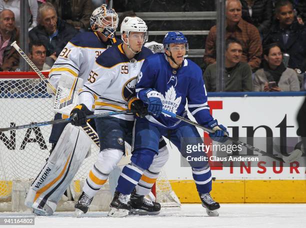 Rasmus Ristolainen of the Buffalo Sabres battles against Andreas Johnsson of the Toronto Maple Leafs during an NHL game at the Air Canada Centre on...