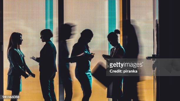 business people silhouettes - medium group of people stock pictures, royalty-free photos & images