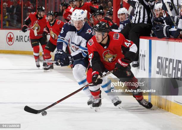 Jean-Gabriel Pageau of the Ottawa Senators controls the puck against Jacob Trouba of the Winnipeg Jets at Canadian Tire Centre on April 2, 2018 in...