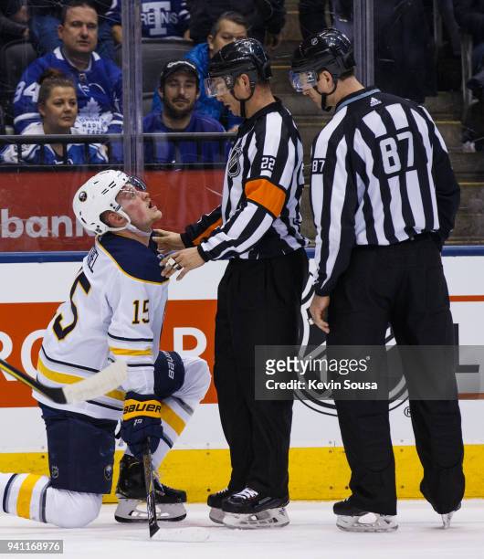 Jack Eichel of the Buffalo Sabres pleads his case to referee Ghislain Hebert and linesman Devin Berg during the first period at the Air Canada Centre...