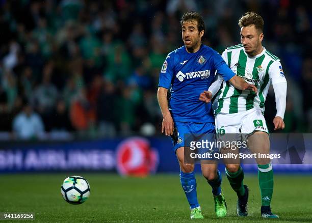 Mathieu Flamini of Getafe competes for the ball with Loren Moron of Real Betis during the La Liga match between Getafe and Real Betis at Coliseum...