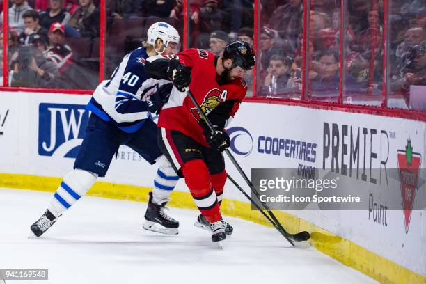 Ottawa Senators Center Zack Smith and Winnipeg Jets Right Wing Joel Armia battle along the boards during first period National Hockey League action...