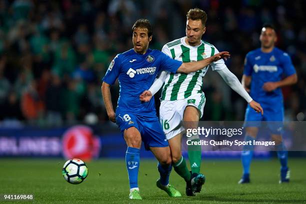 Mathieu Flamini of Getafe competes for the ball with Loren Moron of Real Betis during the La Liga match between Getafe and Real Betis at Coliseum...