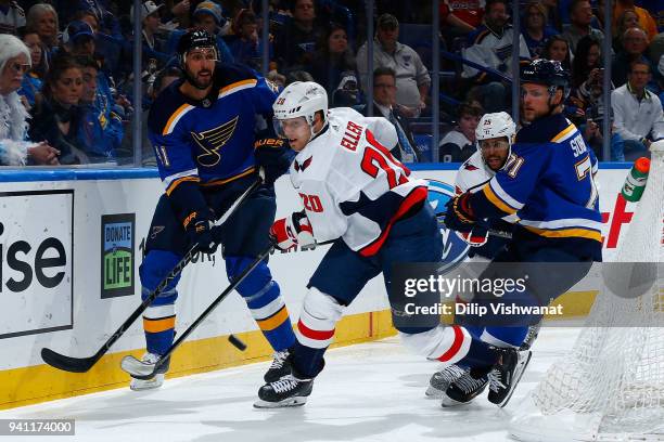 Lars Eller of the Washington Capitals looks to beat Robert Bortuzzo and Vladimir Sobotka of the St. Louis Blues to the puck at Scottrade Center on...