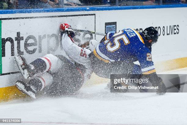 Chris Butler of the St. Louis Blues collides with Devante Smith-Pelly of the Washington Capitals at Scottrade Center on April 2, 2018 in St. Louis,...