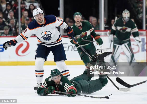 Carson Soucy of the Minnesota Wild passes the puck after being tripped by Anton Slepyshev of the Edmonton Oilers during the first period of the game...