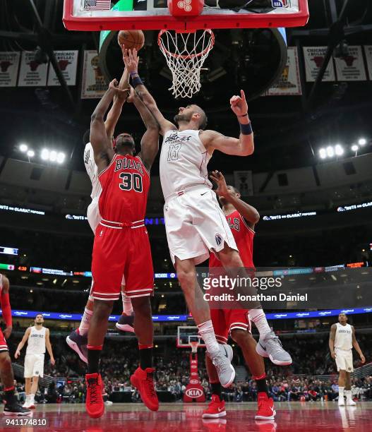 Marcin Gortat of the Washington Wizards tries to block a shot by Noah Vonleh of the Chicago Bulls at the United Center on April 1, 2018 in Chicago,...
