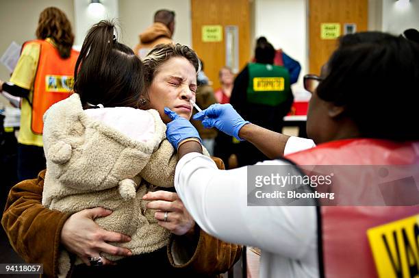 Yadira Ramirez holds her daughter Amanda Ramirez as she receives a nasal H1N1 vaccination during a clinic at St. Barnabas Presbyterian Church in...
