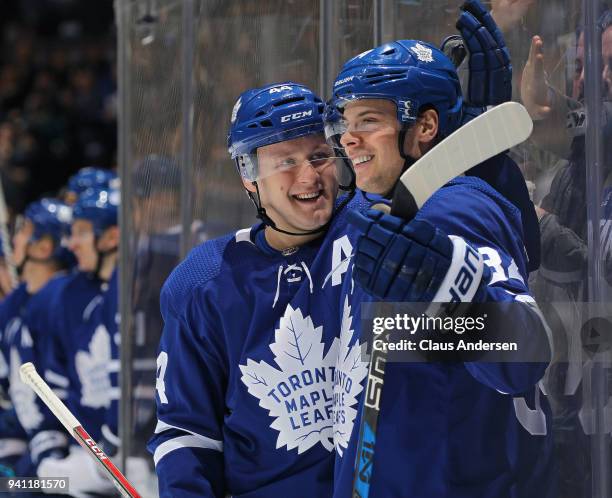 Auston Matthews of the Toronto Maple Leafs celebrates a goal against the Buffalo Sabres with teammate Morgan Rielly during an NHL game at the Air...