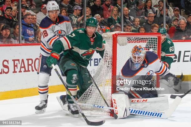 Ryan Strome and Cam Talbot of the Edmonton Oilers defend against Matt Cullen of the Minnesota Wild during the game at the Xcel Energy Center on April...