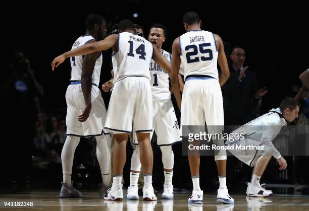 Jalen Brunson of the Villanova Wildcats looks on with teammates at the start of the first half against the Michigan Wolverines during the 2018 NCAA...