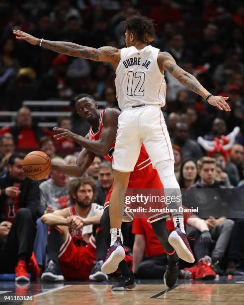 Jerian Grant of the Chicago Bulls looks to pass around Kelly Oubre Jr. #12 of the Washington Wizards at the United Center on April 1, 2018 in...