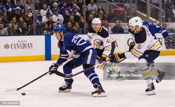 William Nylander of the Toronto Maple Leafs gets away from Justin Falk and Marco Scandella of the Buffalo Sabres and then scores during the second...