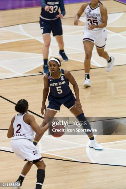 Mississippi State Lady Bulldogs guard Morgan William looks to pass the ball as Notre Dame Fighting Irish guard Jackie Young defends in the National...