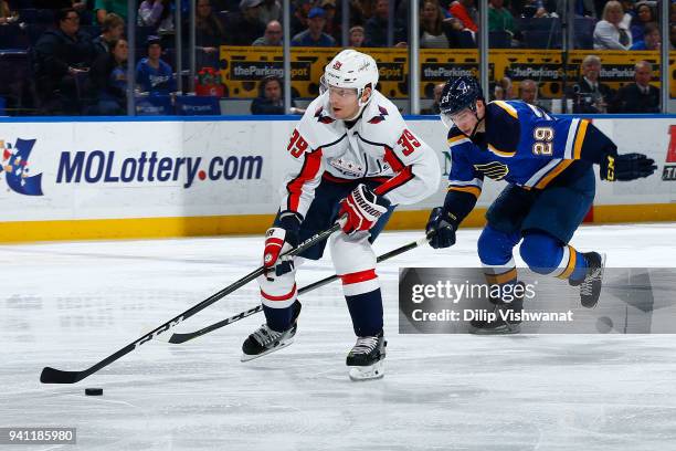 Alex Chiasson of the Washington Capitals on his way to scoring a goal against Vince Dunn of the St. Louis Blues at Scottrade Center on April 2, 2018...