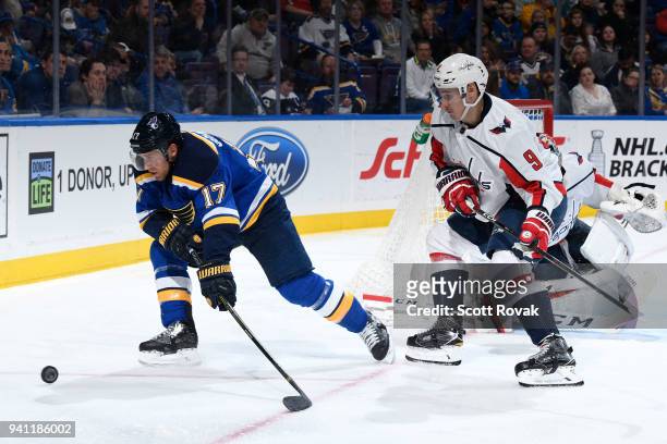 Jaden Schwartz of the St. Louis Blues goes after the puck as Dmitry Orlov of the Washington Capitals pressures at Scottrade Center on April 2, 2018...