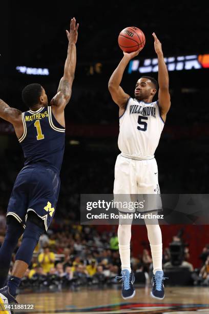 Phil Booth of the Villanova Wildcats attempts a shot defended by Charles Matthews of the Michigan Wolverines in the first half during the 2018 NCAA...