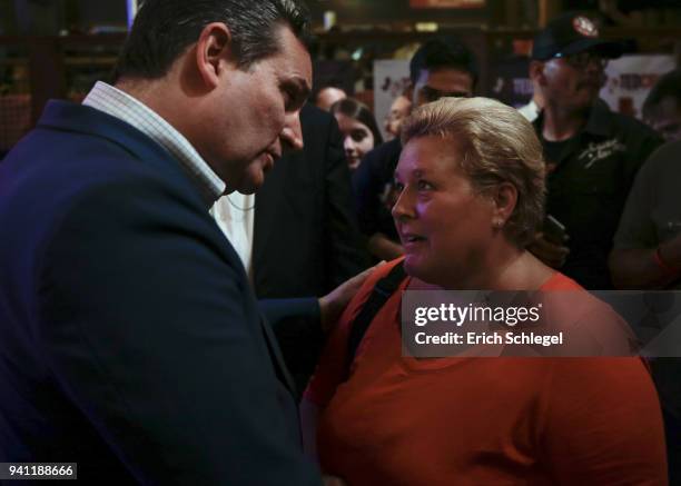 Sen. Ted Cruz talks with supporter Lori Siskey during a rally to launch his re-election campaign at the Redneck Country Club on April 2, 2018 in...