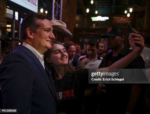 Sen. Ted Cruz talks with supporter Alex Grant during a rally to launch his re-election campaign at the Redneck Country Club on April 2, 2018 in...
