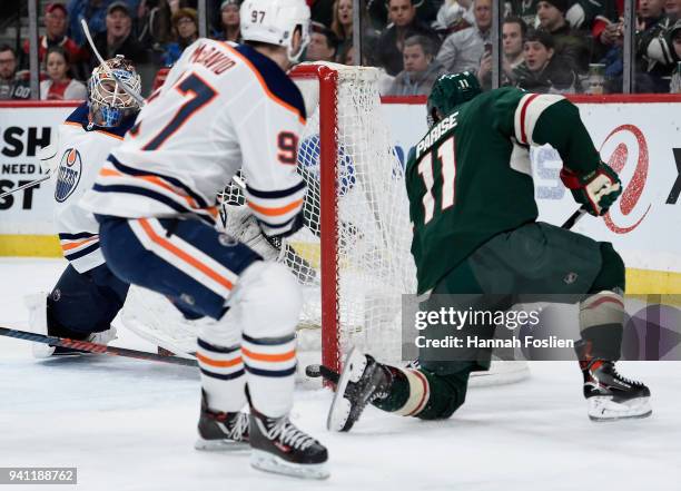 Zach Parise of the Minnesota Wild scores a goal against Cam Talbot and Connor McDavid of the Edmonton Oilers during the second period of the game on...