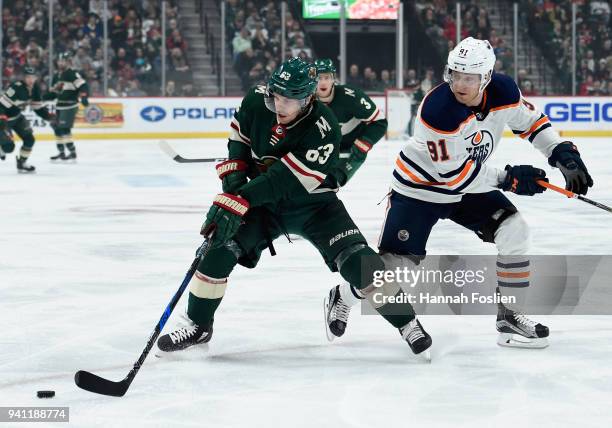 Tyler Ennis of the Minnesota Wild controls the puck against Drake Caggiula of the Edmonton Oilers during the first period of the game on April 2,...