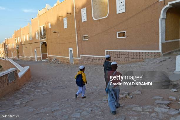 Children walk in the streets of Ksar Tafilelt, self-proclaimed first eco-friendly town of Algeria, near Ghardaia, some 600 km south from Algiers, on...