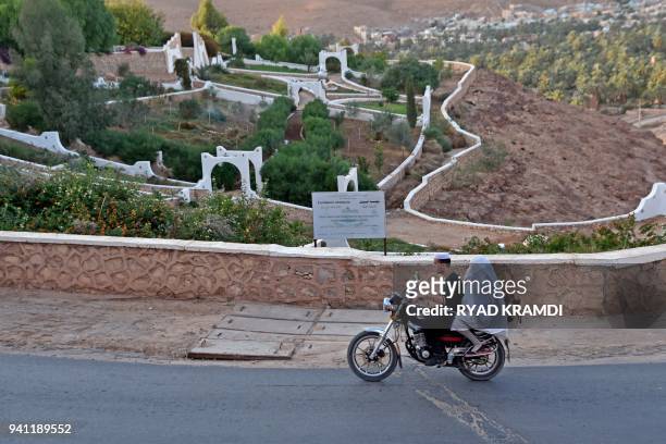 Algerans ride a motorbike on the road leading to Ksar Tafilelt, the self-proclaimed first eco-friendly town of Algeria, near Ghardaia, some 600...