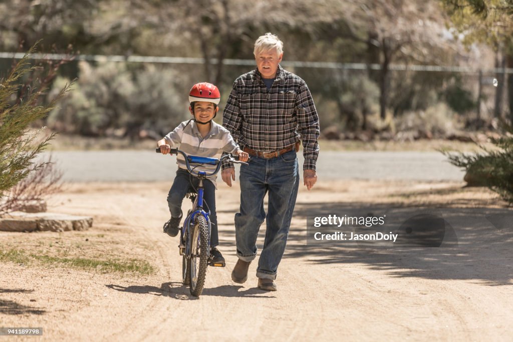 Grandfather Teaching Grandson Bicycle Riding