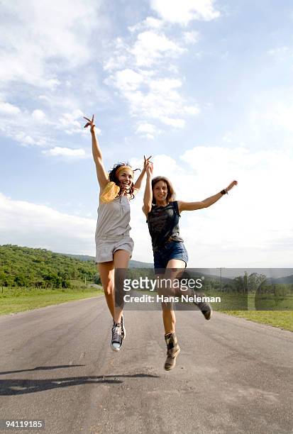 two women enjoying on the road, san miguel de tucuman, argentina - leap forward stock pictures, royalty-free photos & images