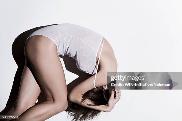 woman curled up in the fetal position, knysna, western cape province, south africa - body silhouette photos et images de collection