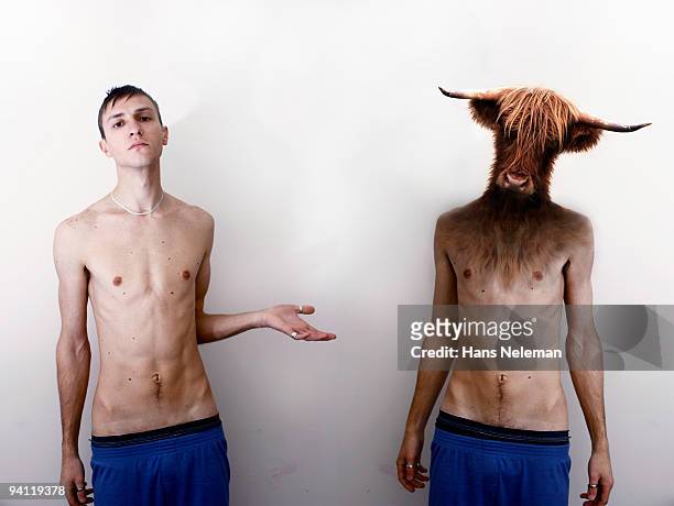 man standing beside another man with a cow head - encuadre de tres cuartos fotografías e imágenes de stock