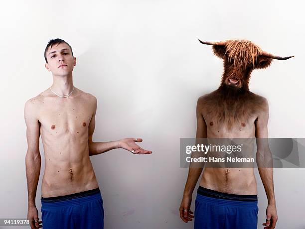 man standing beside another man with a cow head - animal macho imagens e fotografias de stock