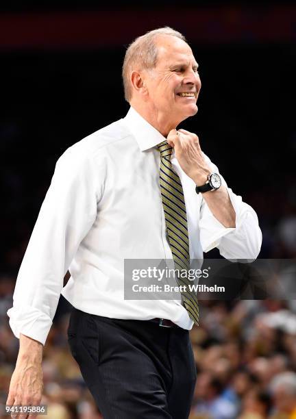 Head coach John Beilein of the Michigan Wolverines tightens his tie during the first half of the 2018 NCAA Photos via Getty Images Men's Final Four...