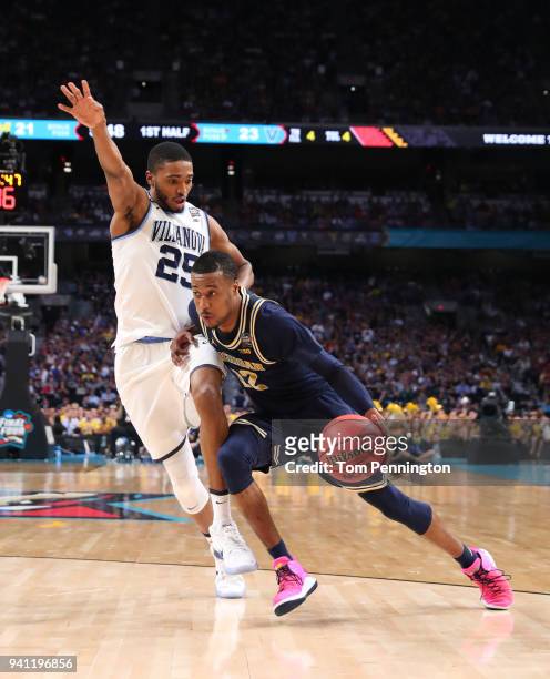 Muhammad-Ali Abdur-Rahkman of the Michigan Wolverines is defended by Mikal Bridges of the Villanova Wildcats in the first half during the 2018 NCAA...