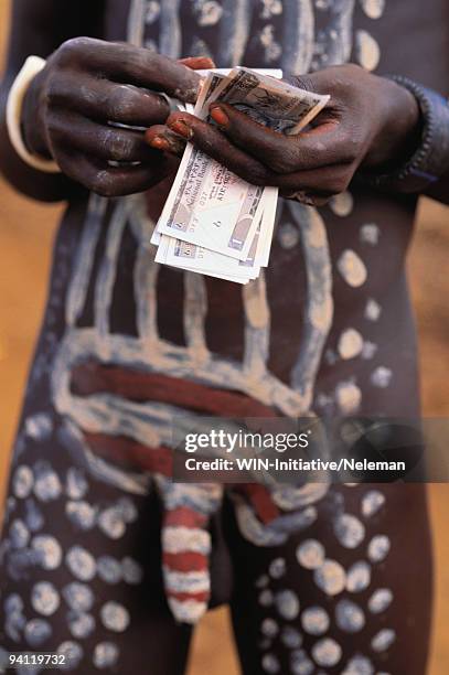 mursi tribal man counting money - greed stock pictures, royalty-free photos & images
