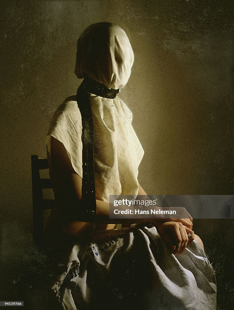 Woman sitting on a chair with obscured face, Lugansk, Ukraine