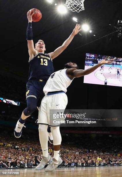Moritz Wagner of the Michigan Wolverines drives to the basket against Eric Paschall of the Villanova Wildcats in the second half during the 2018 NCAA...