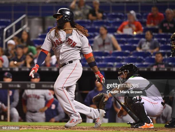 Hanley Ramirez of the Boston Red Sox singles in the ninth inning during the game against the Miami Marlins at Marlins Park on April 2, 2018 in Miami,...