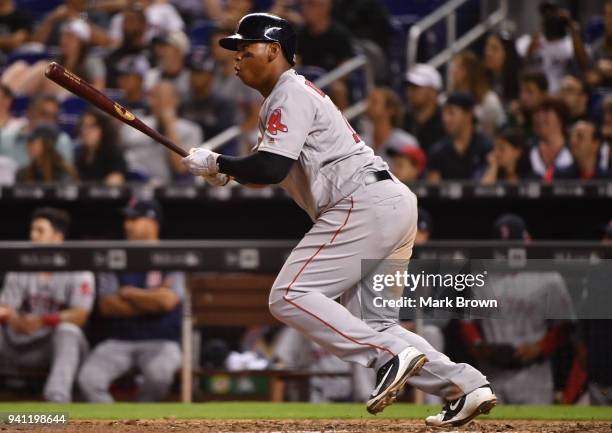 Rafael Devers of the Boston Red Sox doubles in the ninth inning during the game against the Miami Marlins at Marlins Park on April 2, 2018 in Miami,...